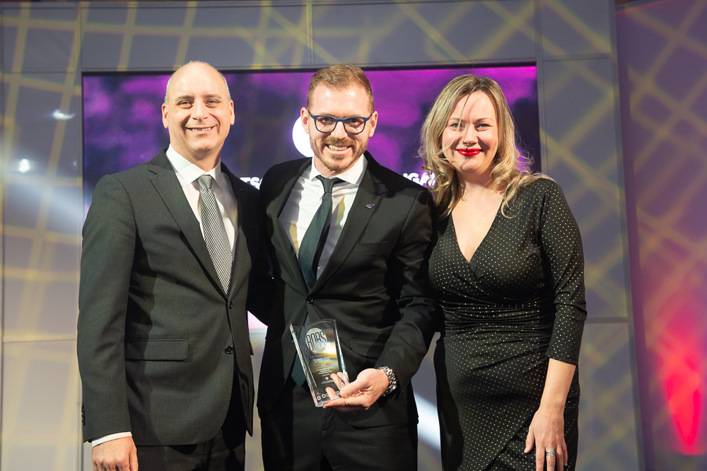 Joel Tkach (Ottawa Airport Authority) and Hugo Germain (Germain Hotels) receive award from sponsor, Perley-Robertson Hill and McDougall LLP (Representative Megan Wallace).